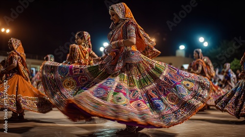 A group of women in traditional indian clothing dance during the navratri festival in gujarat, india