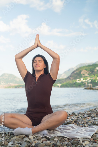 Relaxing on the coast woman meditating by the sea serenity and wellness peaceful outdoor lifestyle scene