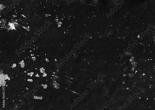 Black paper background with white paint stains. Grunge texture background template for overlay design.