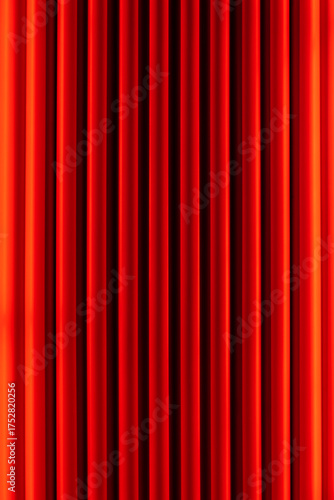 vibrant red velvet curtains with vertical pleats, creating a rich, textured background. The curtains are evenly spaced, with a slight sheen that highlights their luxurious fabric.