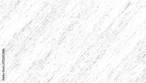 A white surface with a dense pattern of fine diagonal gray lines and scattered speckles.