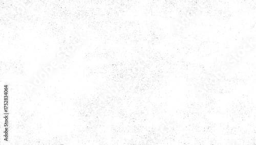 A white surface with a sparse, random distribution of small black dots creating a textured effect.