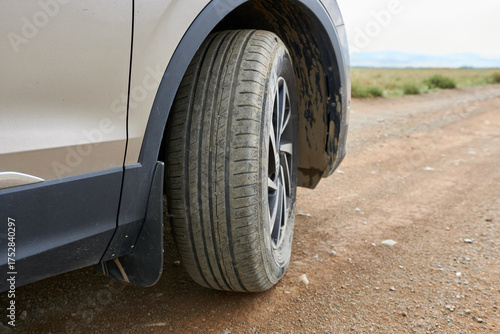 A car wheel on a rural road. Car trip.
