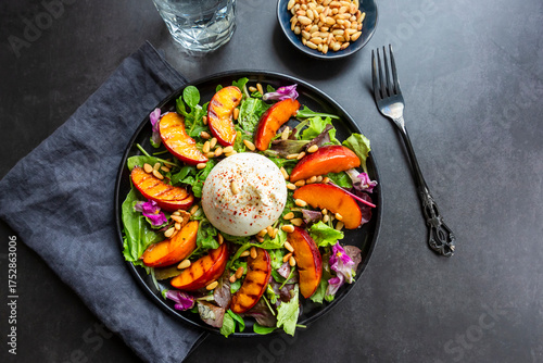 Grilled nectarine salad with burrata, pine nuts and edible flowers