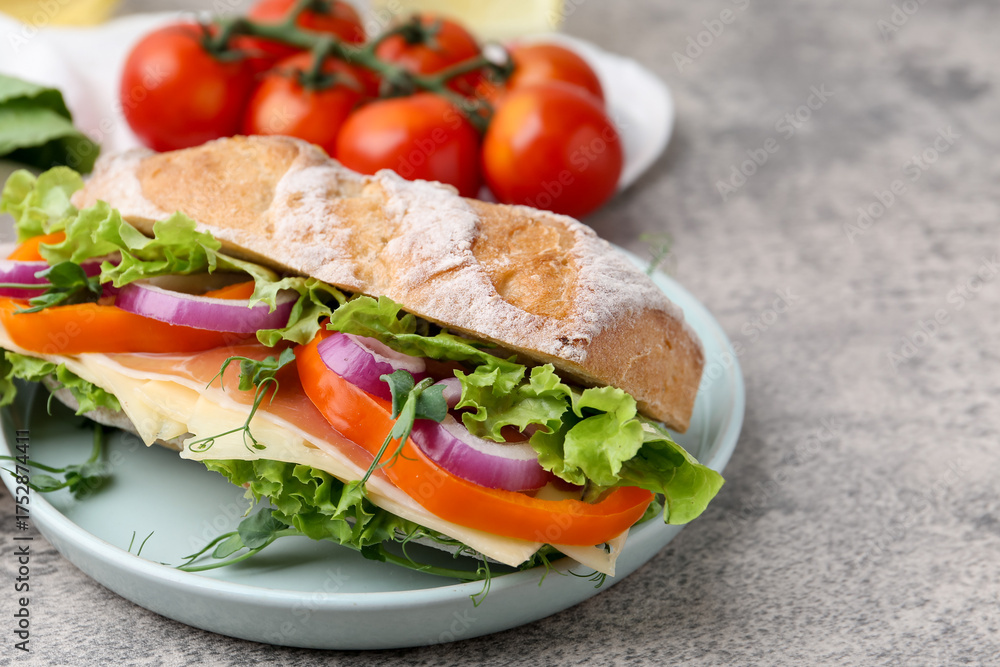 Obraz premium Delicious ciabatta sandwich with prosciutto, cheese and vegetables on light grey table, closeup. Space for text