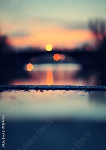 Blurry sunset over water and bridge