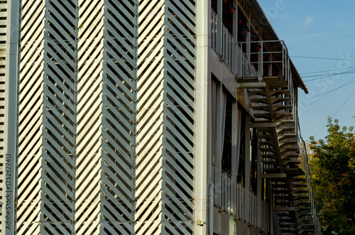 White wood planks create a herringbone pattern on the building facade.