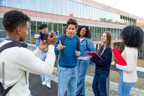 Diverse students interviewing on campus for journalism project