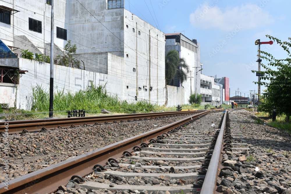 Naklejka premium Railway Line Passing Urban Buildings