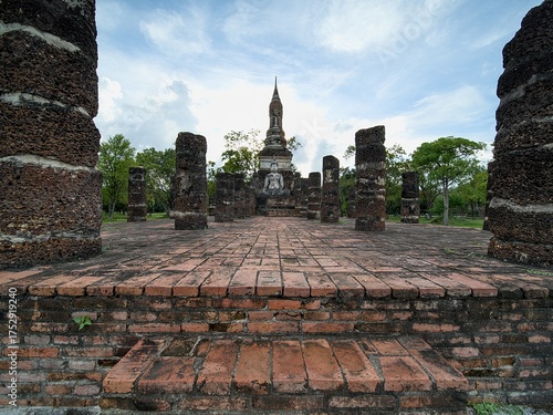 A brick walkway leads to a large building