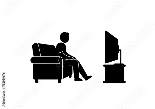 A silhouette person sits watching television in a living room.