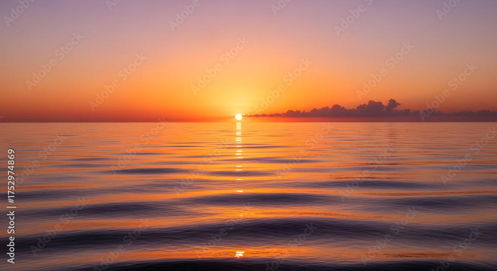 Naklejka premium A serene sunset over the ocean casting a golden light on the water surface creating a peaceful atmosphere