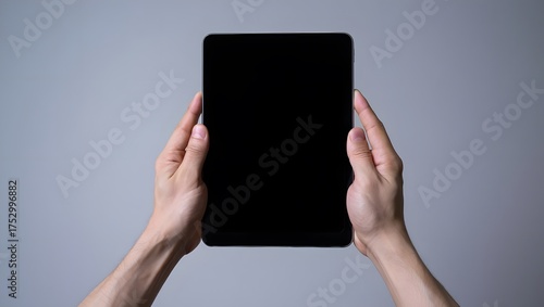 hands hold tablet pro device against white background. Digital tech, blank screen for app, web design. Portable smart device, communication, modern design, tech usage,