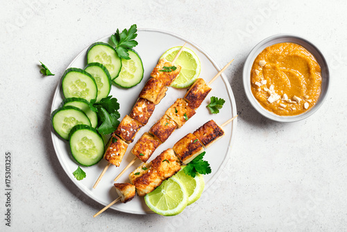 Grilled tofu satay skewers and peanut spicy sauce