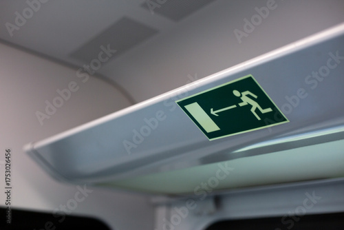 Train emergency exit sign, highlighting the safety measures in place for passengers. It emphasizes evacuation procedures, ensuring safe journey for everyone on board