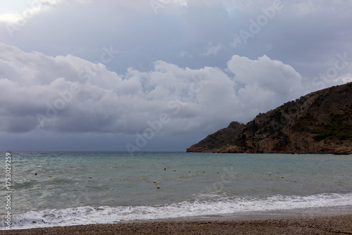 Sunrise over the sea with gentle waves washing the sandy beach, reflecting the golden sunlight. Peaceful and harmonious natural landscape.