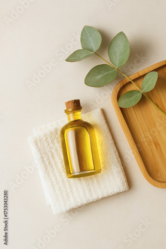 Oil Bottle And Eucalyptus Leaf On A Neutral Background With A Wooden Tray