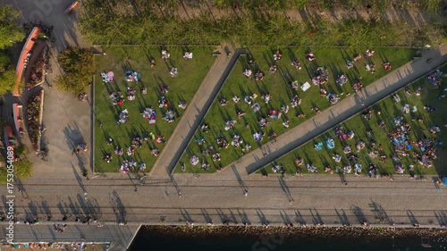 Aerial drone view of locals picnicking on the grass in the Superkilen Park, Norrebro, Copenhagen, Denmark