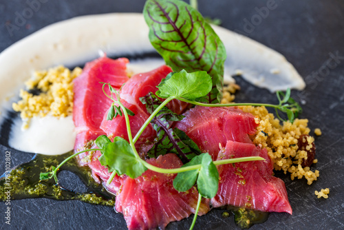 Close up of a fresh raw tuna served with couscous on the side