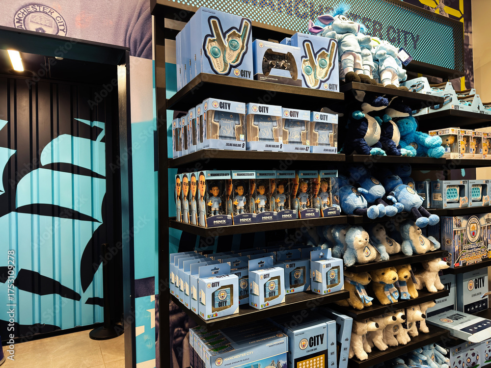 Fototapeta premium Store display of Manchester City merchandise with plush toys and boxed collectibles