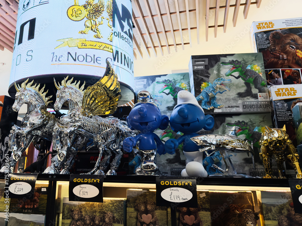 Naklejka premium Vibrant store display with fantasy figures dinosaurs unicorns and a large digital banner