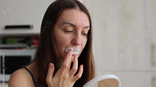Woman applying cream mask on her lips. Problem dry skin, big pores and wrinkles concept. 4K.