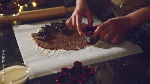 Close Up of Hands Cutting Gingerbread Cookie Dough for Christmas Baking