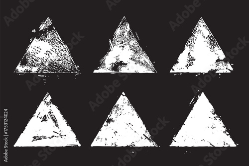Set with hand drawn strokes of paint. White forms of a triangle isolated on a black background. Artistic design elements.