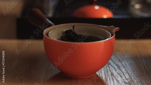 Close-up of a tea cup in a traditional tea ceremony. Gentle steam and warm light create a calm, relaxing, and cozy atmosphere. Cinematic 4K footage perfect for wellness, lifestyle, and advertising pro