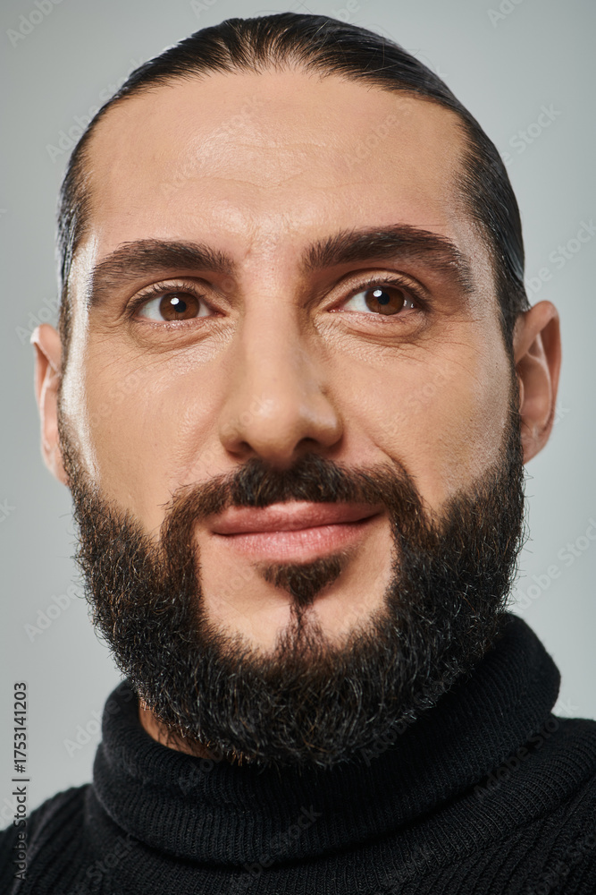Fototapeta premium Handsome middle eastern man with a beard showcasing a stylish studio look