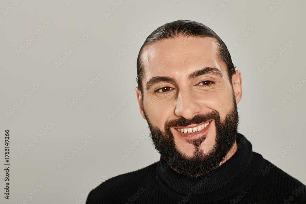 Obraz premium Handsome middle eastern man smiles confidently in stylish studio setting