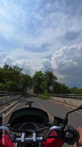 Vertical Footage First Person View of the Upper Bridge being crossed by riding a red automatic scooter. Videography Riding an automatic scooter on the bridge in first-person P0V shot in 4K Resolution