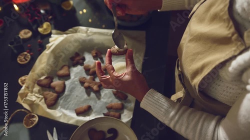 Decorating Festive Gingerbread Cookies with White Icing for the Christmas Holiday Season