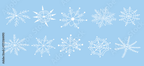 Hand-drawn white snowflakes on a blue background. Vector illustration of snowflakes in doodle style. Festive frosty elements in a minimalist style. Snowflake icons, snow symbol. Snow