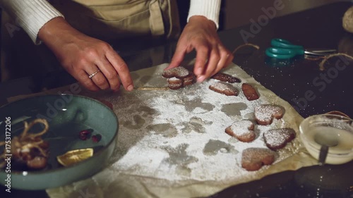 Woman Decorating Delicious Heart Cookies with Twine and Dried Citrus