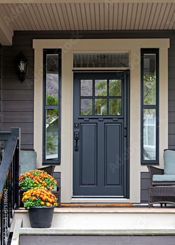 Porch and entrance of a nice residential house with two flower pots