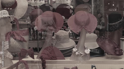 Cinematic view of a hat shop window displaying a variety of hats and caps. Warm evening light creates a cozy and welcoming atmosphere. Perfect for travel, lifestyle and advertising projects.