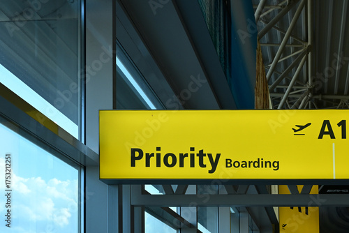Airport sign indicating Priority Boarding for selected passengers, displayed in a terminal setting