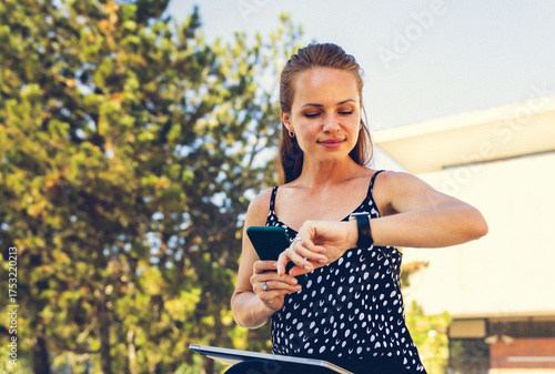 Lifestyle technology concept, woman with smartphone and smartwatch