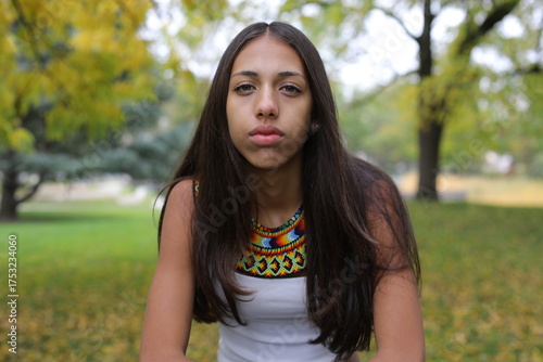 Fotografie Serious young ethnic woman wearing beaded collar
