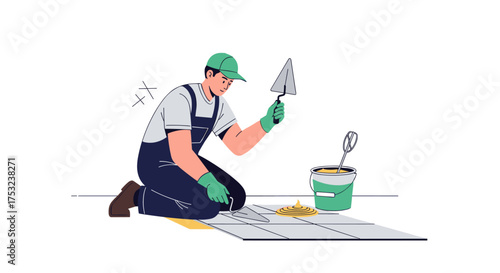 A construction worker meticulously laying tiles with a trowel on the floor.