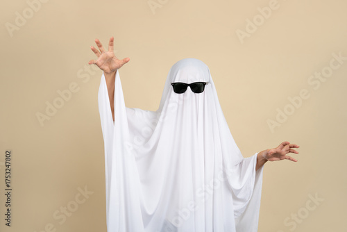 Child dressed up in white costume of scary ghost for Halloween