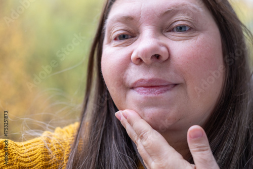 Tableau sur toile close-up view facial skin, woman examines her fat neck, saggy chin with visible