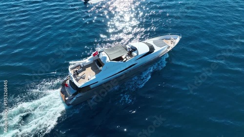 A luxury yacht cruising smoothly across the turquoise Mediterranean waters on a calm summer day.