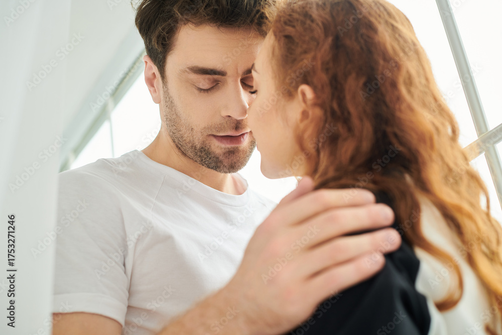 Fototapeta premium Couple cherishing quiet moments together at home during weekend mornings