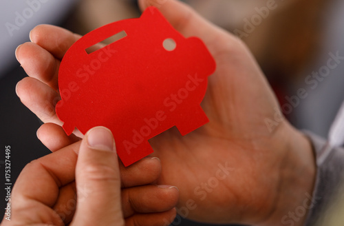 A person's hands hold a red...
