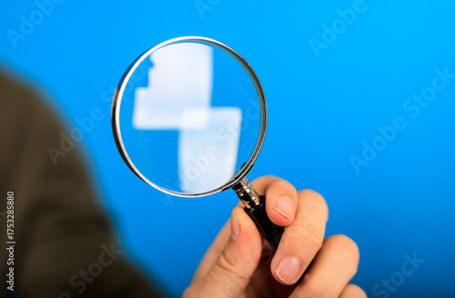Person holding a magnifying...
