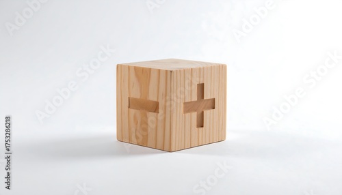 A simple wooden cube featuring cut-out plus and minus signs, set against a pristine white backdrop. Natural wood grain is visible