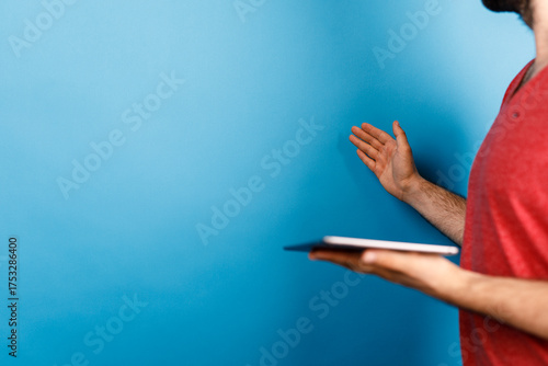 A man in a red shirt gestur...