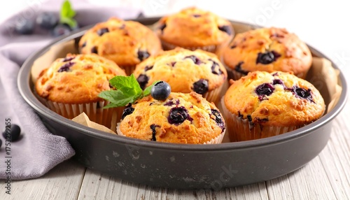 Wallpaper Mural Baked golden muffins with blueberries in a round pan on wood Torontodigital.ca